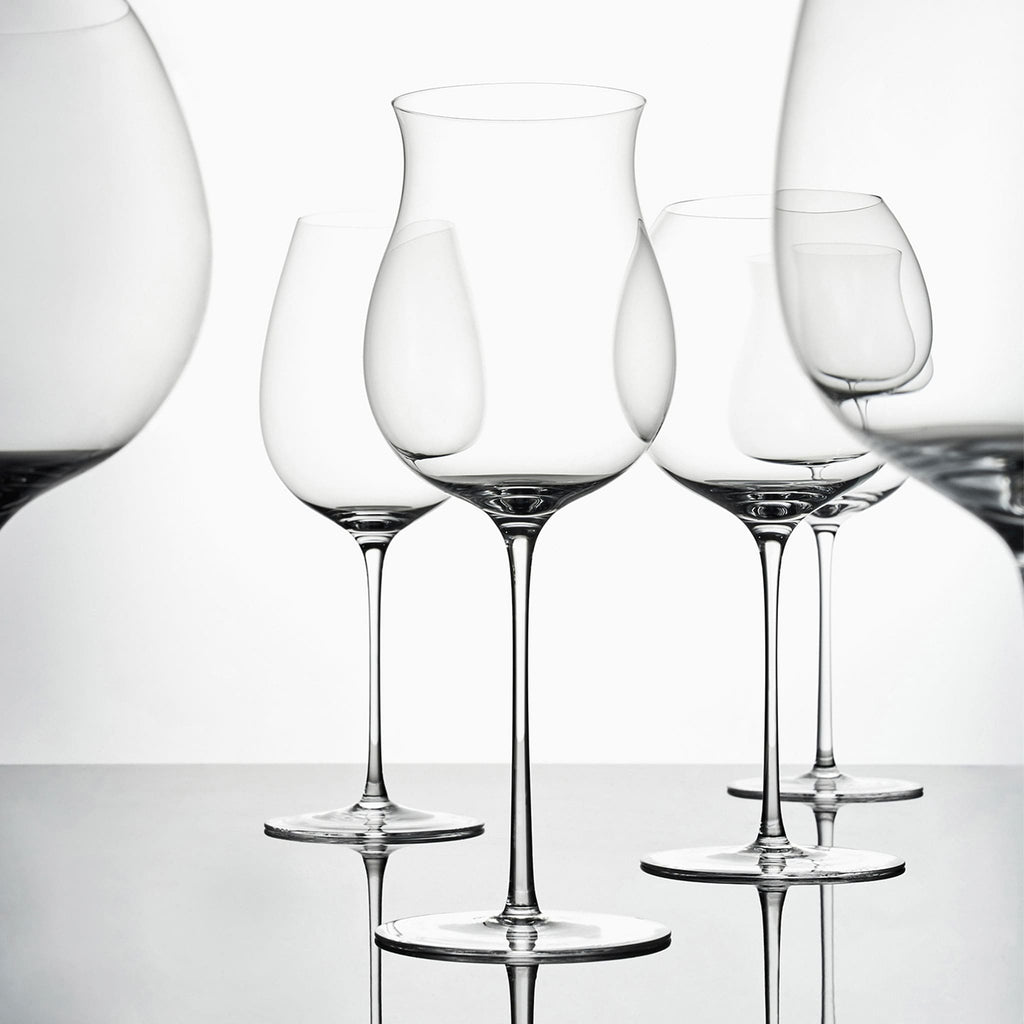 Close-up of hand-blown crystal wine glass showing ultra-thin rim, clear body, and refined stem detail