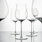 Close-up of hand-blown crystal wine glass showing ultra-thin rim, clear body, and refined stem detail
