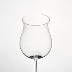 Close-up of hand-blown crystal wine glass showing ultra-thin rim, clear body, and refined stem detail