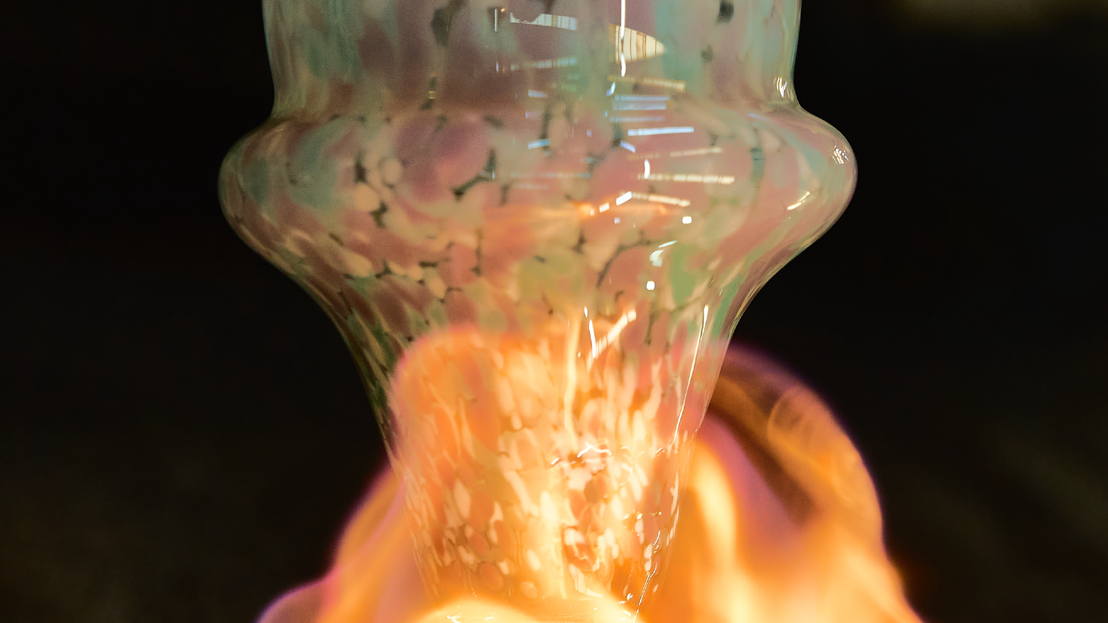 Glass object with colorful swirls on a black background