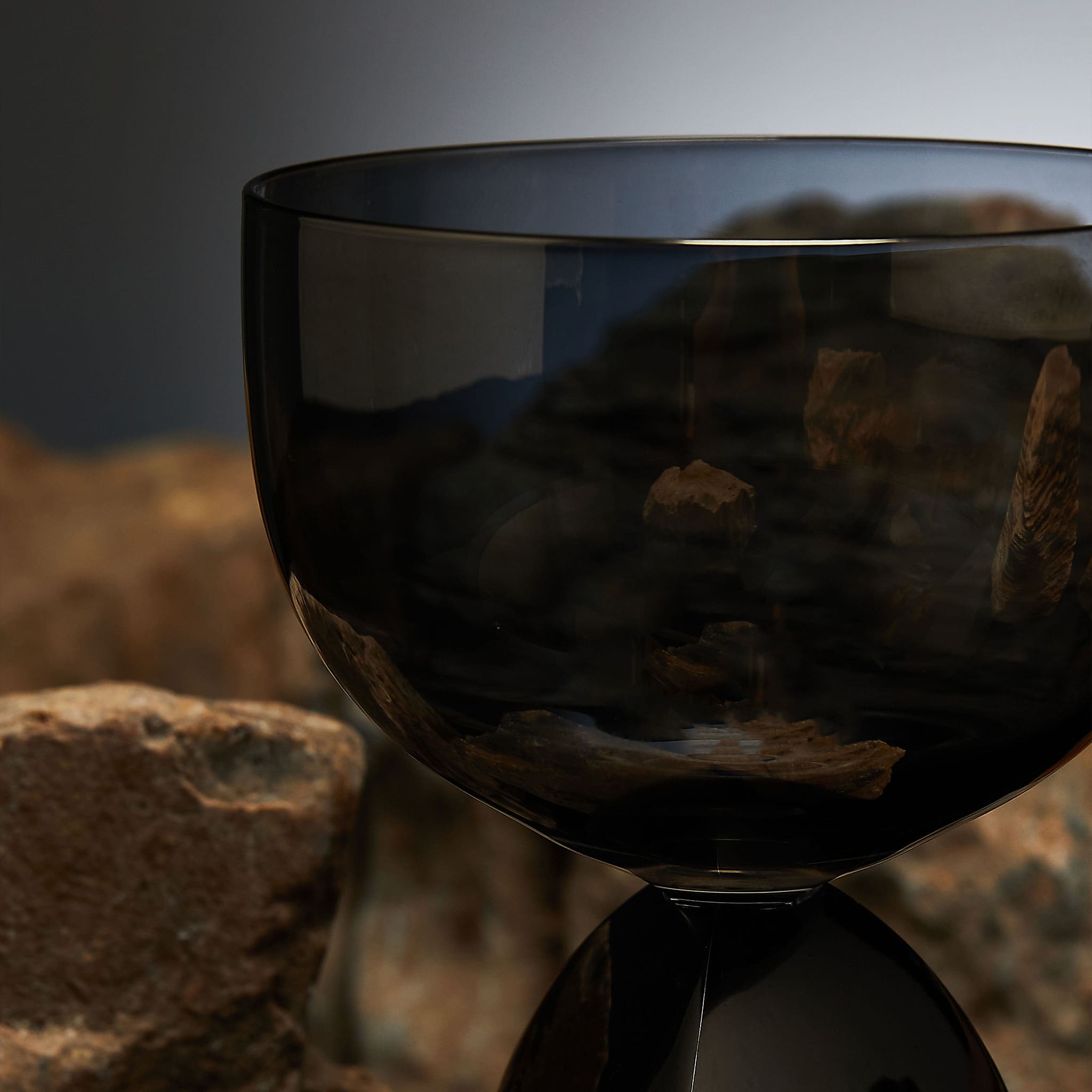 Close-up of crystal drinking glass showing electroplated color, mirror metal finish, and refined glass-to-metal detail