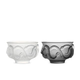 Glaze glass tea cup set in soft light with Year of the Snake relief texture and ebony wood coaster