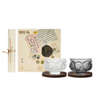 Glaze glass tea cup set in soft light with Year of the Snake relief texture and ebony wood coaster