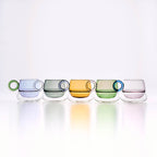 Ciambelle Transparent glass coffee cup in soft light with a rounded sculptural silhouette