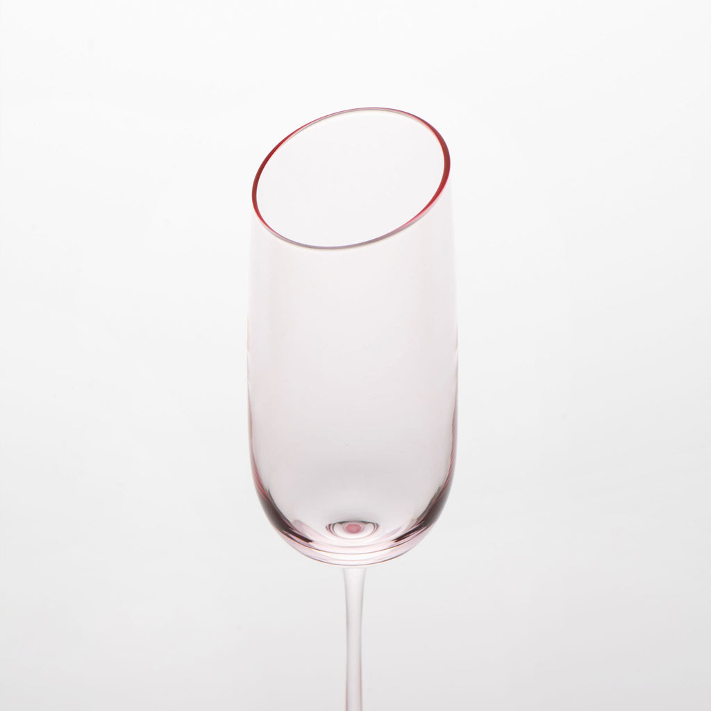 Close-up of crystal champagne glasses showing the angled rim, 4 mm stem, and soft pink glass detail