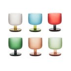 Dolce Antiqua glazed glass cup in soft light with a book-inspired sculptural silhouette