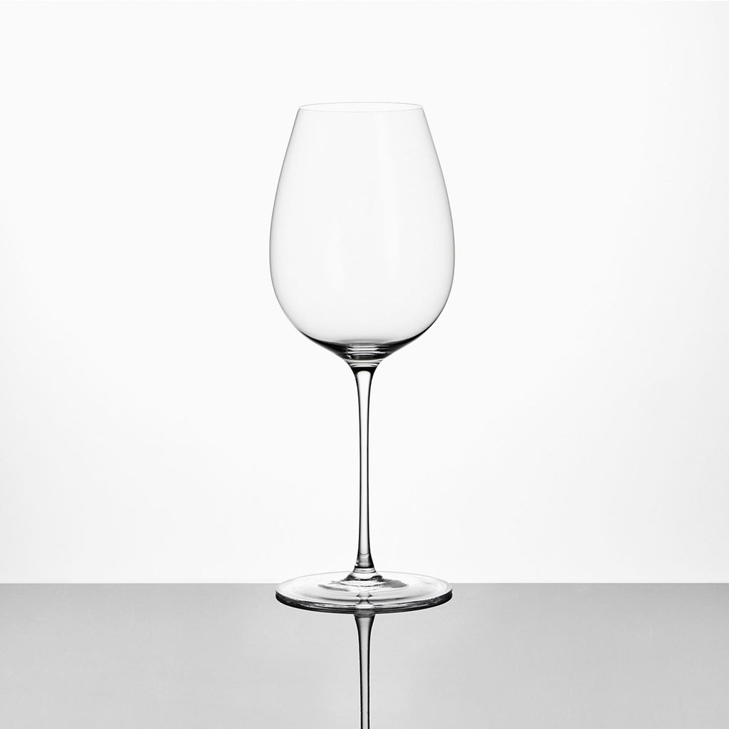Close-up of hand-blown crystal wine glass showing ultra-thin rim, clear body, and refined stem detail