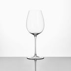 Close-up of hand-blown crystal wine glass showing ultra-thin rim, clear body, and refined stem detail