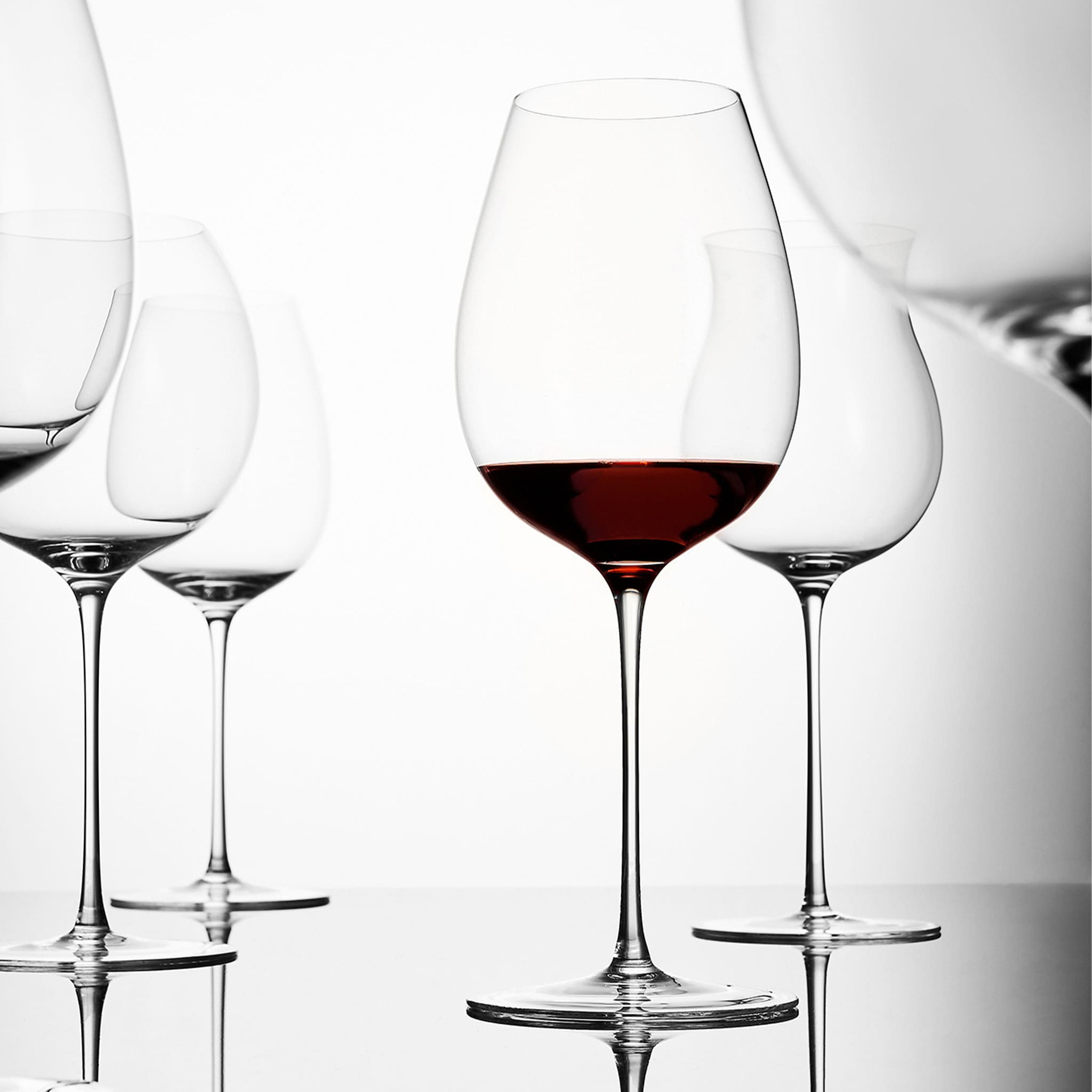 Close-up of hand-blown crystal wine glass showing ultra-thin rim, clear body, and refined stem detail
