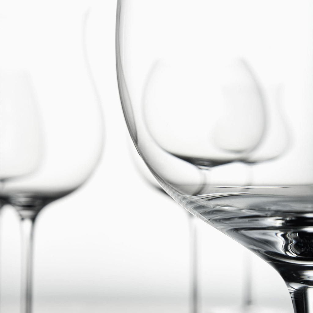 Close-up of hand-blown crystal Chardonnay glass showing ultra-thin rim, clear body, and refined stem detail