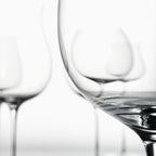 Close-up of hand-blown crystal Chardonnay glass showing ultra-thin rim, clear body, and refined stem detail
