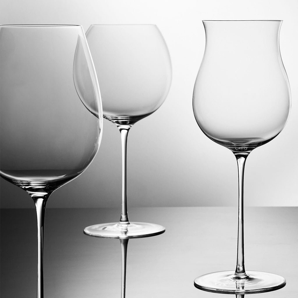 Close-up of hand-blown crystal Chardonnay glass showing ultra-thin rim, clear body, and refined stem detail