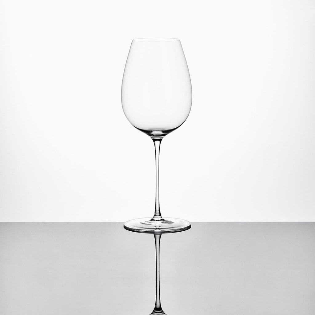Close-up of hand-blown crystal wine glass showing ultra-thin rim, clear body, and refined stem detail