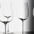Close-up of hand-blown crystal wine glass showing ultra-thin rim, clear body, and refined stem detail