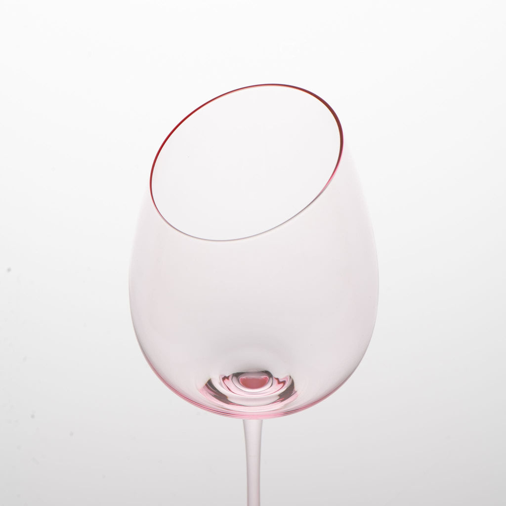 Close-up of crystal wine glasses showing the angled rim, 4 mm stem, and soft pink glass detail