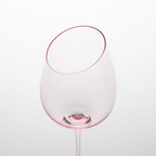 Close-up of crystal wine glasses showing the angled rim, 4 mm stem, and soft pink glass detail