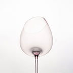 Close-up of crystal wine glasses showing the angled rim, 4 mm stem, and soft pink glass detail