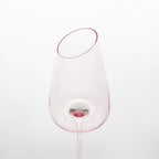 Close-up of crystal wine glasses showing the angled rim, 4 mm stem, and soft pink glass detail
