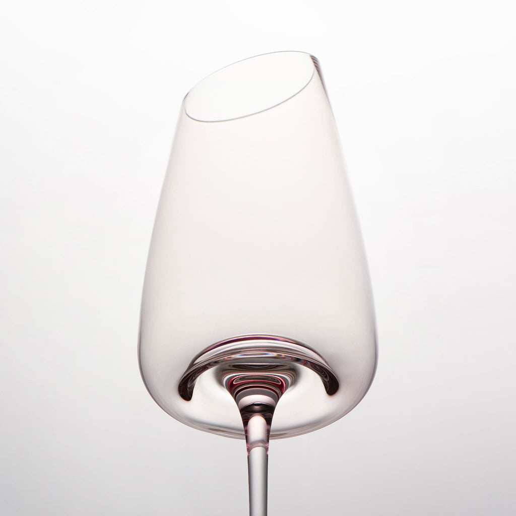 Close-up of crystal wine glasses showing the angled rim, 4 mm stem, and soft pink glass detail