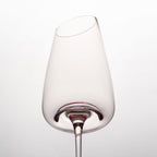Close-up of crystal wine glasses showing the angled rim, 4 mm stem, and soft pink glass detail