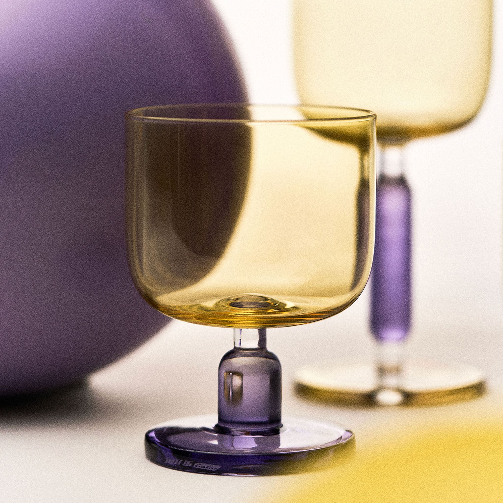 Close-up of the jelly-inspired glass showing transparent color, sculptural body, and thickened base detail