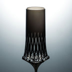 Close-up of Love Aphrodite Champagne Glass Set showing hand-carved glass texture, transparent cuts, and dark metallic stem detail