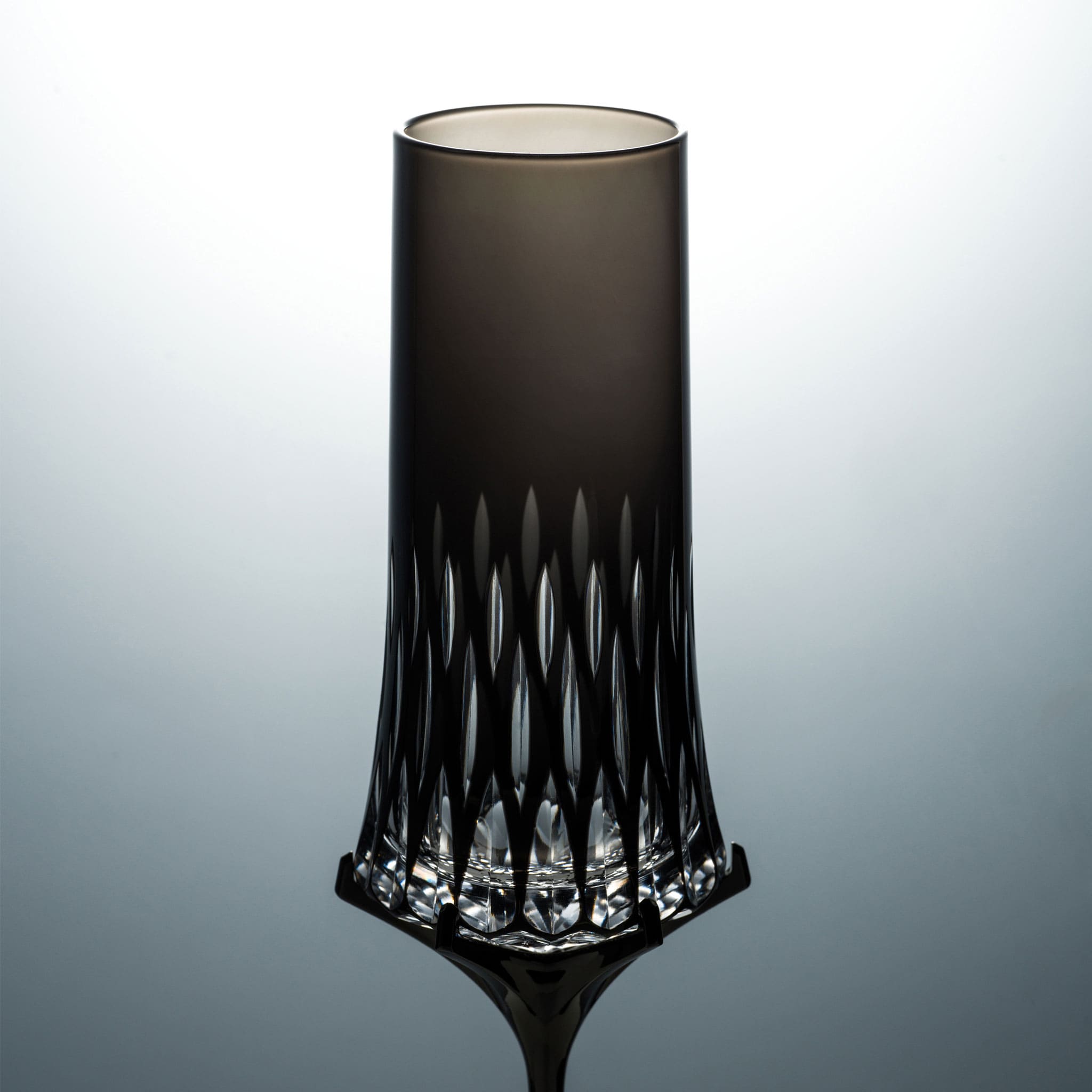 Close-up of Love Aphrodite Champagne Glass Set showing hand-carved glass texture, transparent cuts, and dark metallic stem detail