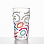Memphis Milano beer glass in soft light with bold graphic detail and a tall sculptural silhouette