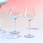 Bordeaux and Burgundy wine glass set styled for a quiet wine ritual with a soft ocean-inspired mood