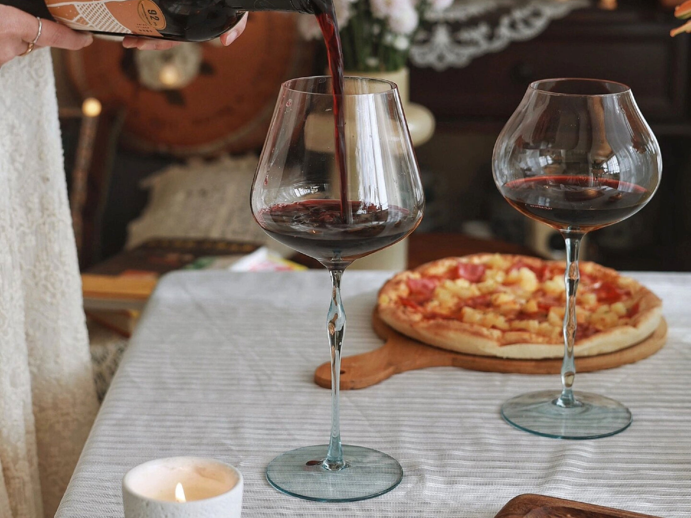 Bordeaux and Burgundy wine glass set styled for a quiet wine ritual with a soft ocean-inspired mood