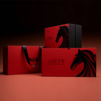 Red gift boxes with black horse designs on a dark background