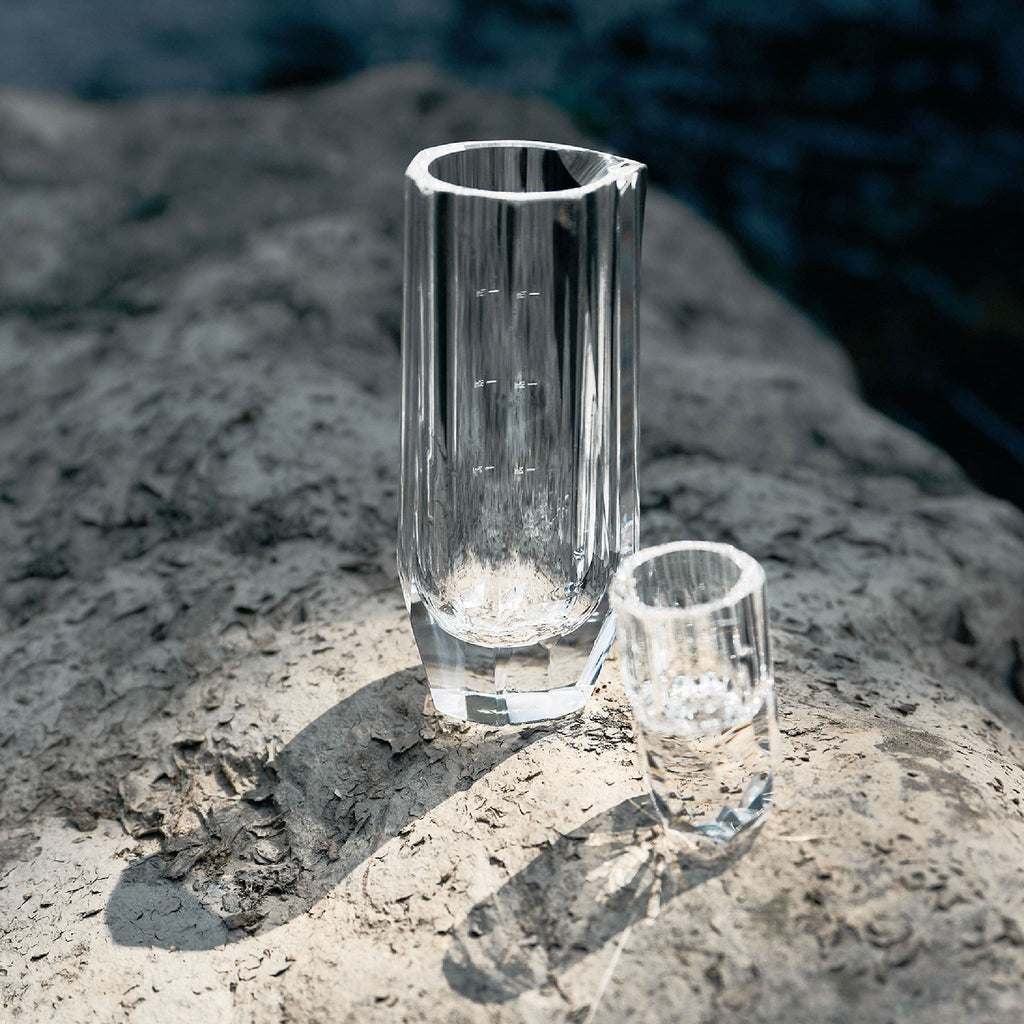 Crystal baijiu glass styled for a quiet drinking ritual with bright reflections and a weighted base