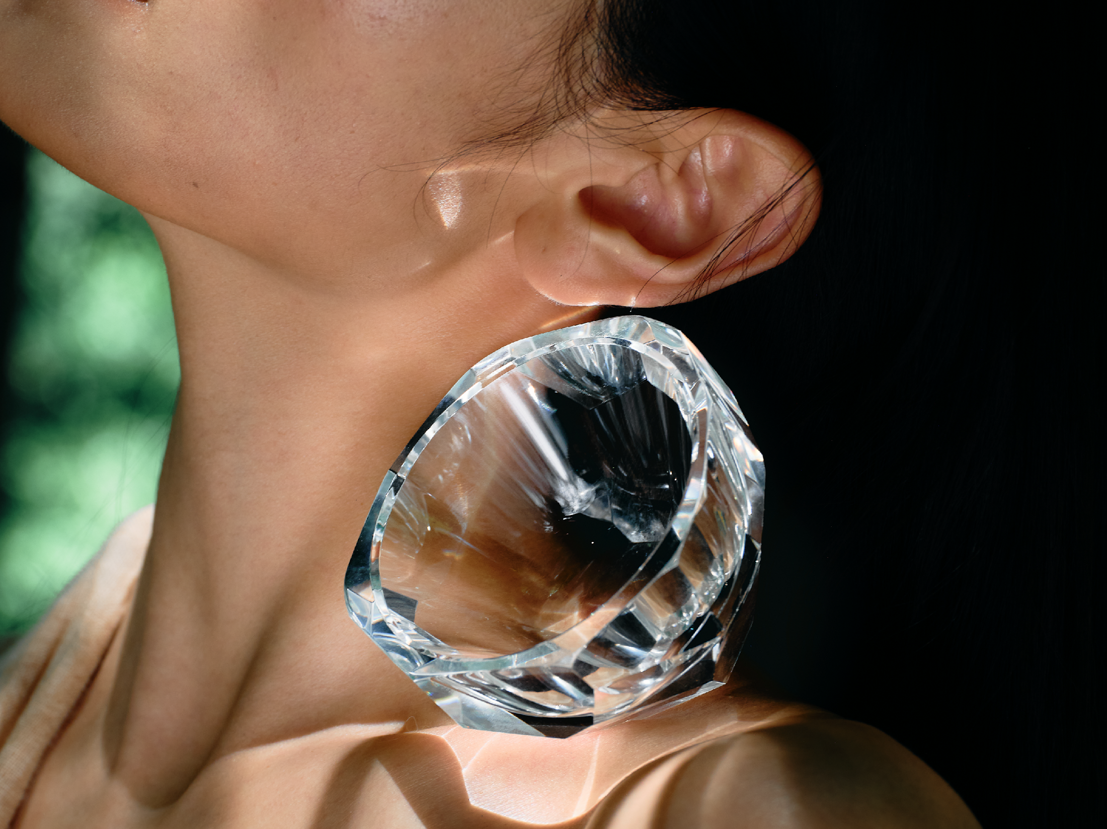 Close-up of crystal tea cup showing gemstone-like facets, polished edges, and weighted crystal detail
