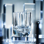 Raw Enigma whiskey glass styled for a quiet bar ritual with bright reflections and a weighted base