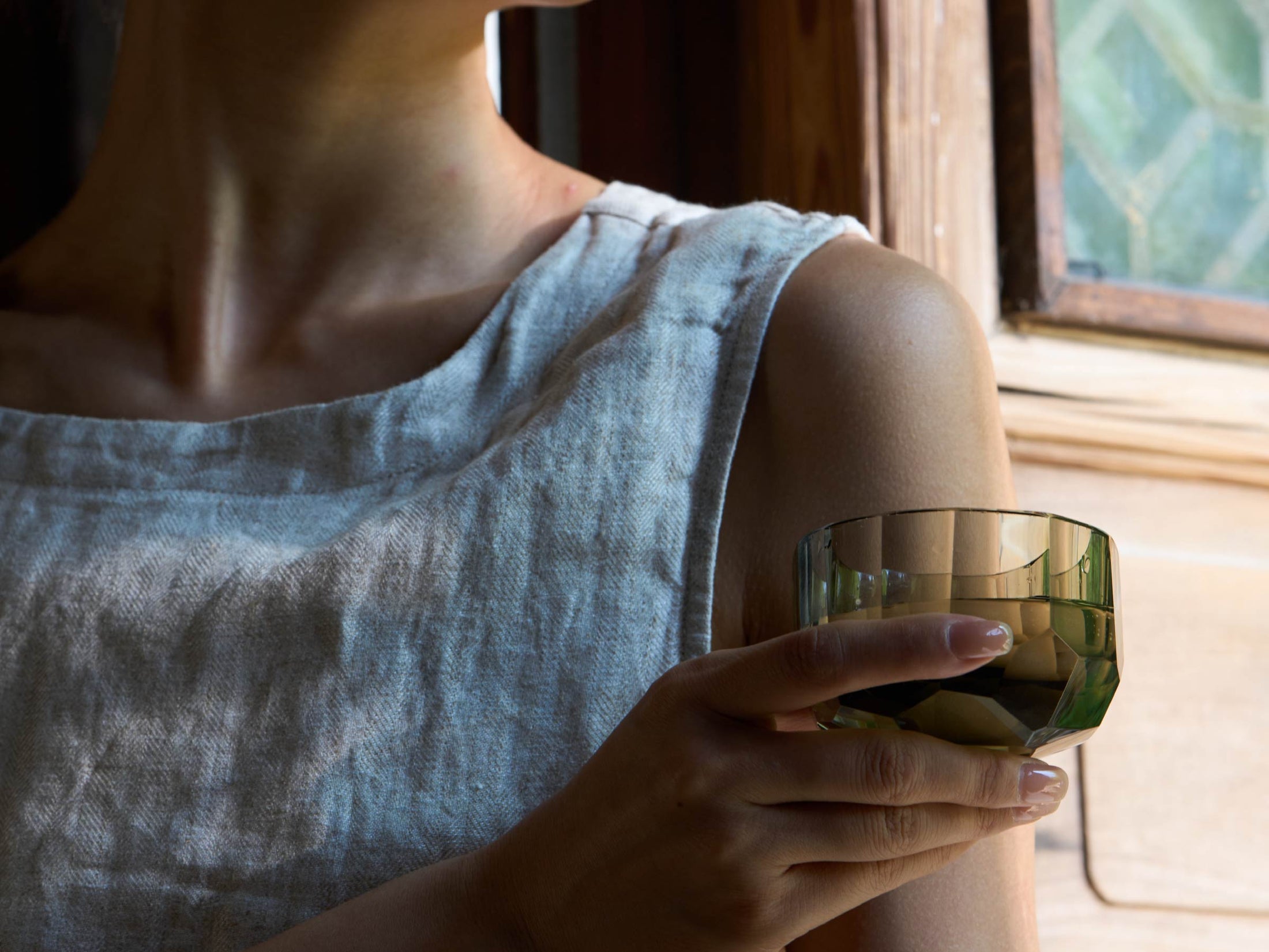 Raw Enigma tea cup styled for a quiet tea ritual with bright reflections and a weighted form