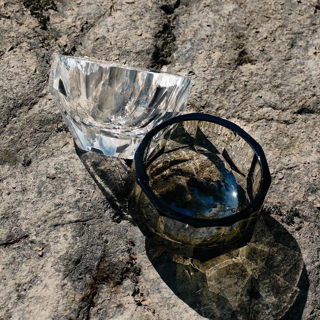 Close-up of crystal tea cup showing gemstone-like facets, polished edges, and weighted crystal detail