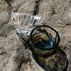 Close-up of crystal tea cup showing gemstone-like facets, polished edges, and weighted crystal detail