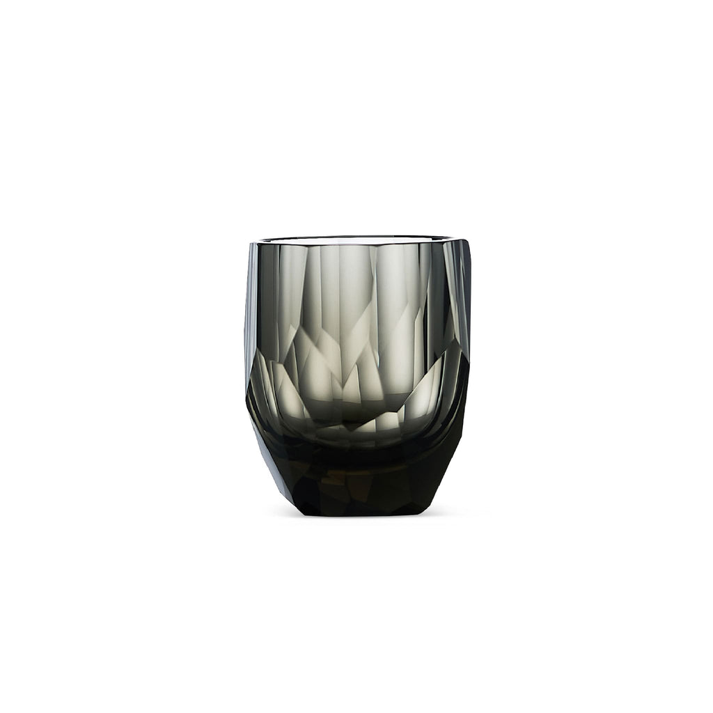 Crystal whiskey glass in soft light with raw diamond-inspired facets and brilliant reflective detail