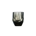 Crystal whiskey glass in soft light with raw diamond-inspired facets and brilliant reflective detail