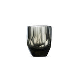 Crystal whiskey glass in soft light with raw diamond-inspired facets and brilliant reflective detail
