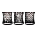 Wild Crystal whiskey glass in soft light with wild animal-inspired carved texture and a bold sculptural silhouette