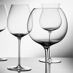 Close-up of hand-blown crystal wine glass showing ultra-thin rim, clear body, and refined stem detail