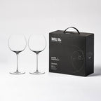 Close-up of hand-blown crystal wine glass showing ultra-thin rim, clear body, and refined stem detail