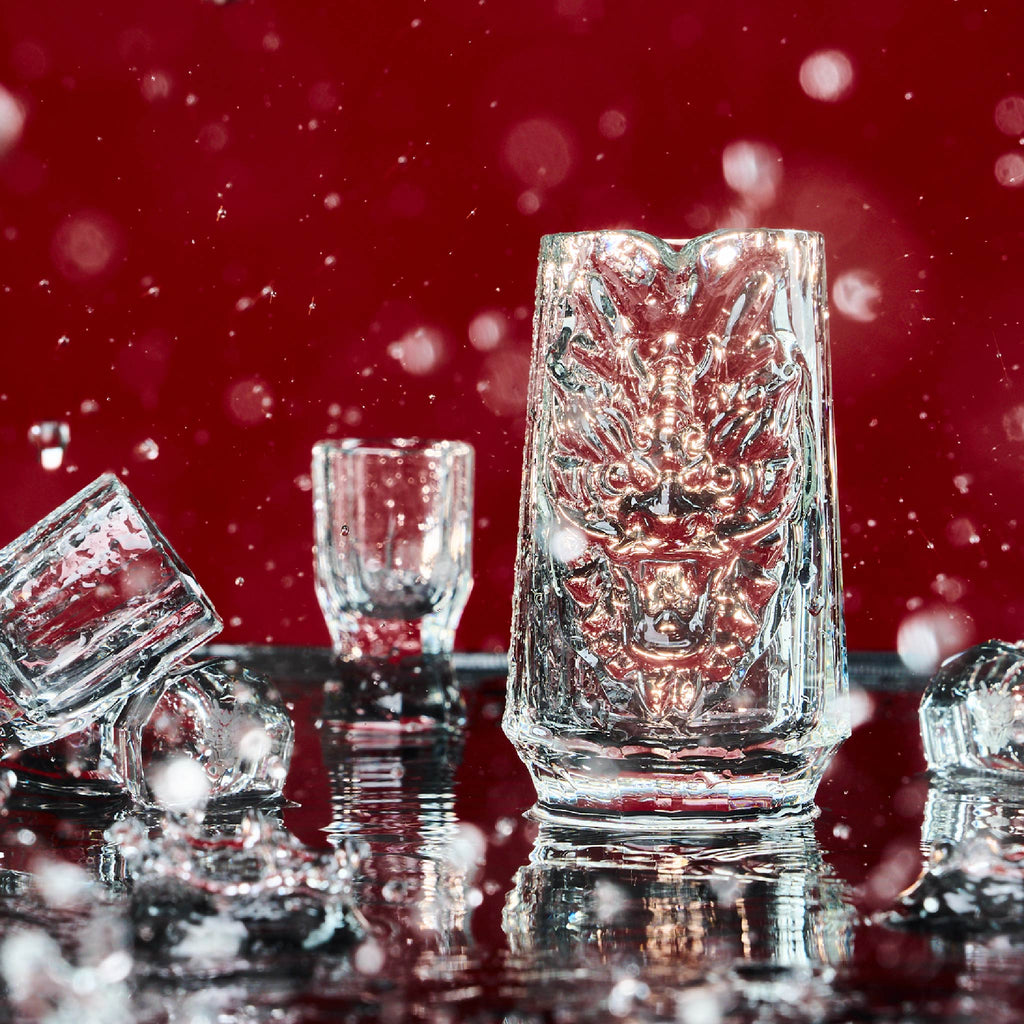 Chinese baijiu gift set styled for a quiet gathering with a sculptural dragon decanter and crystal cups