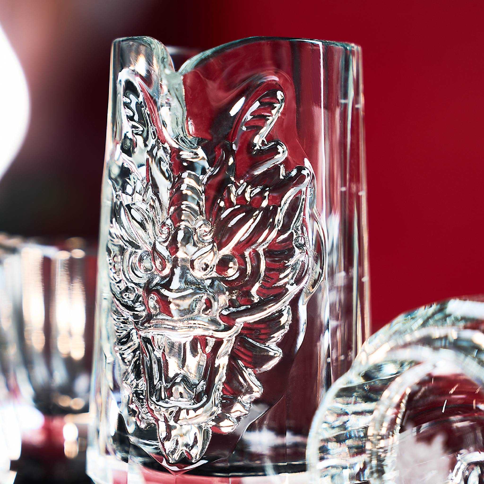 Close-up of dragon baijiu set showing sculpted dragon detail, polished crystal facets, and black K5 crystal finish